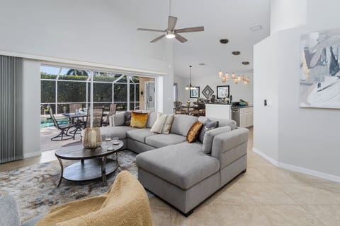 Relax in your stylish living room with plush sectional seating and views of your private pool area.