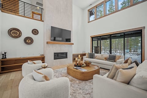 Sink into plush seating by your crackling fireplace, surrounded by soaring ceilings and forest views that bring nature's tranquility indoors.