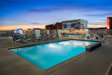 Unwind at dusk with a glowing rooftop pool escape.