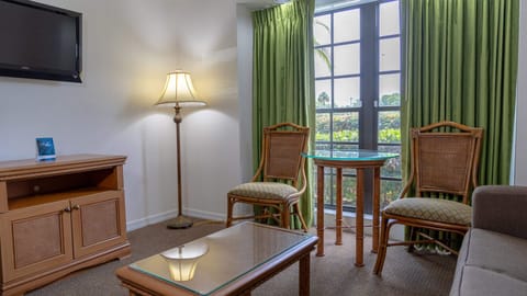 Sip morning coffee beside bright windows and cozy seating.