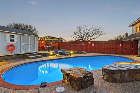 Relax in your private oasis featuring a pool, patio sent, and a shaded pergola.
