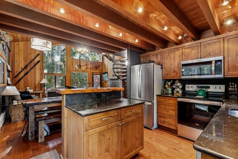 You'll love cooking in this stunning rustic kitchen with exposed beams, granite counters, and modern appliances.