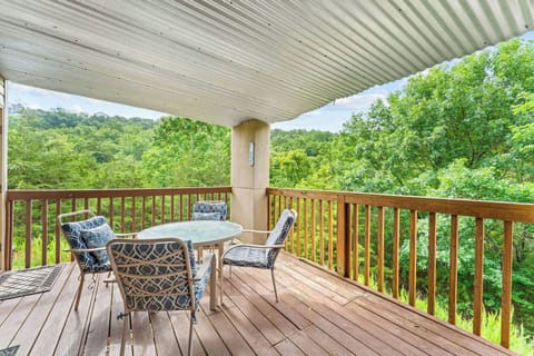 Enjoy your morning coffee or evening drinks on this covered balcony, complete with seating and tranquil views of the surrounding trees.