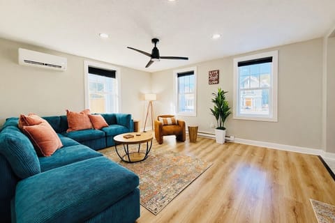 Spacious living room with plush sectional seating, modern ceiling fan, and abundant natural light. A comfortable spot to relax after a day of exploring Sandusky and the surrounding attractions.