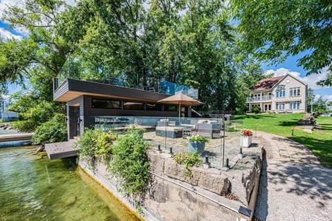 Lakeside patio with cozy fire pit and shaded seating