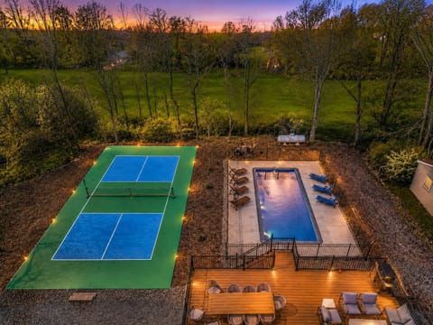 Backyard Oasis with heated inground pool, private pickleball court, and spacious deck seating