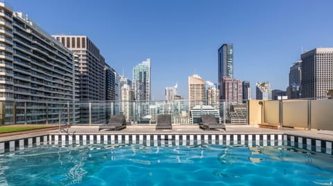 Stunning roof top pool with sun loungers and sweeping city views