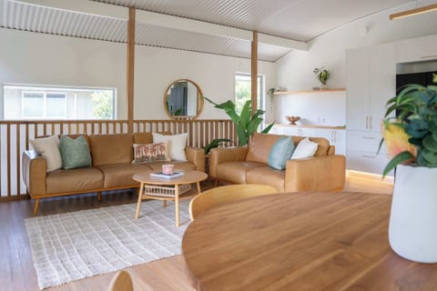 Warm, modern living with natural textures and effortless style ✨ Featuring caramel leather sofas, soft neutral tones, and timber accents that create a cozy yet contemporary space perfect for relaxing or entertaining.