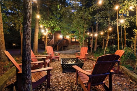 Gather around your private fire pit under twinkling string lights, where Adirondack chairs await cozy evenings beneath towering trees.