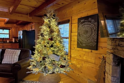 Cozy up in your rustic cabin where twinkling Christmas lights create magical holiday memories by the fireplace.