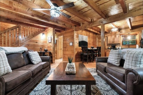 Sink into rich leather sofas surrounded by warm wood beams and rustic charm in your cozy cabin retreat.
