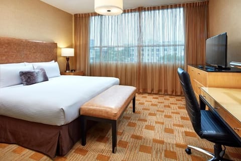 Wake up to soft daylight in this spacious bedroom.