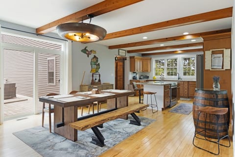 Large farmhouse table, open kitchen, perfect for group meals.