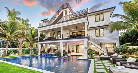 Welcome to Lido Lumiére! This modern coastal home stands out with layered balconies and sleek finishes.