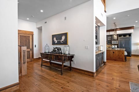 Enter the main floor to find the staircase leading to your third-floor master suite, elevator access, and wet bar, all within steps. The thoughtful layout becomes clear immediately: luxury, convenience, and smart design greeting you from the moment you ar