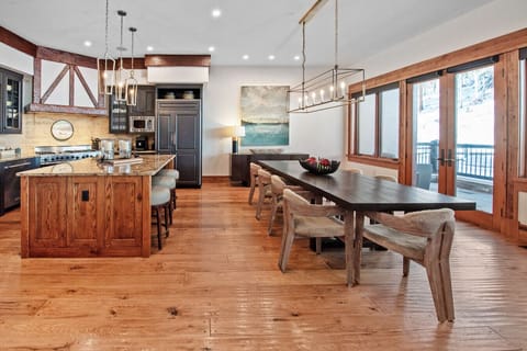 The dining table seats 10 with three additional bar stools at the kitchen island. Step onto the adjacent deck for outdoor dining with direct views of the catwalk, watch skiers while you enjoy meals alfresco. Space for everyone, inside and out.