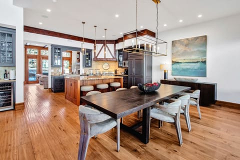 The dining area opens to the chef`s kitchen equipped with oversized refrigerator, gas range, island workspace, dishwasher, microwave, and dedicated coffee center. Cook together, host dinners, or simply enjoy breakfast before the slopes