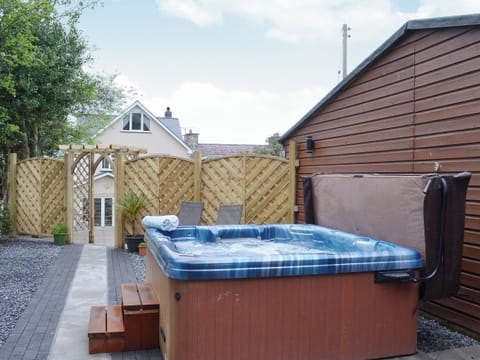 Relax in the private, secluded hot tub | Oswald House, Llanon, near Aberaeron
