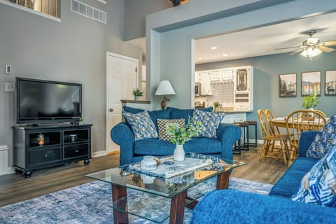 A cozy living room anchored by a fireplace, sleeper sofa and large windows, creating the perfect spot to relax after a day in the Poconos.