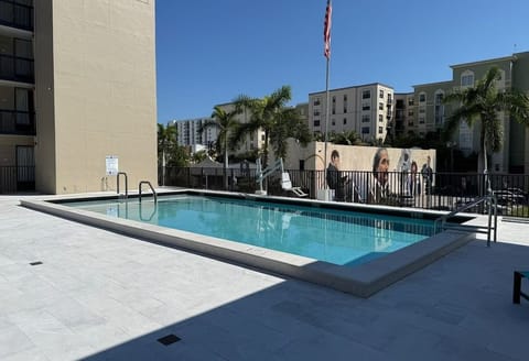 Unwind poolside under blue skies with refreshing city vibes.
