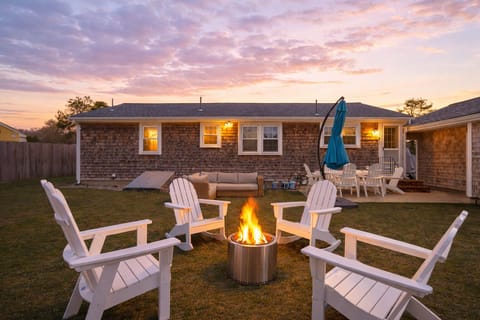 Backyard with dining for 6, firepit, grill and lounge seating.