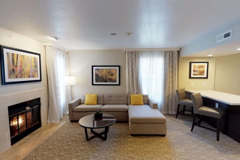 Gather by the glowing fireplace and sink into the cozy sectional.