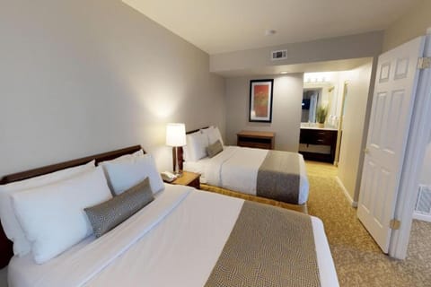 Unwind in crisp beds with a calm, spacious retreat.