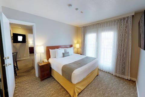 Unwind in crisp linens beside soft, glowing bedside lamps.