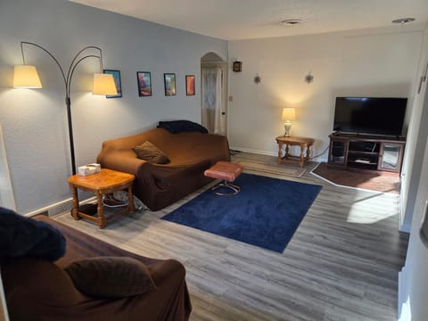 Living room on main floor. The TV has Roku and is on guest mode.
