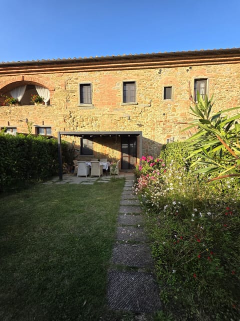 Private fenced garden with view of the covered gazebo with table and chairs. 