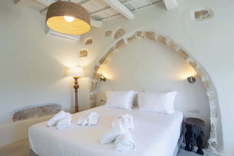 Elegant Double Bed Set Within a Traditional Stone Arch and Soft Ambient Lighting