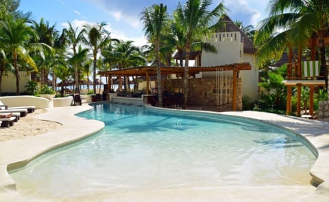 Sip poolside cocktails beside a tranquil swim-up bar lagoon.