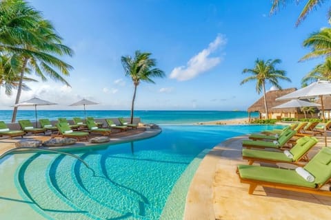 Dive into an ocean-view infinity pool under endless blue skies.