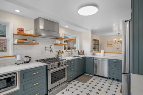 Fully equipped kitchen with modern appliances and ample prep space.