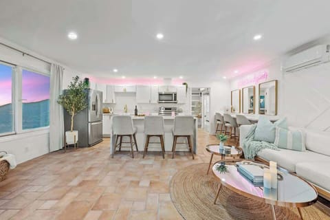 A chic and inviting open-concept space with modern elegance, warm textures, and a touch of glam.