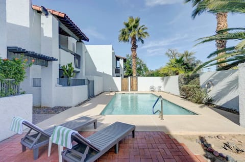 Relaxing community pool surrounded by palm trees and lounge seating