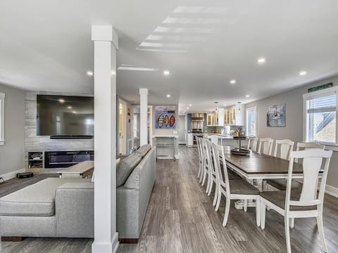 The expansive open-plan living area features a large sectional sofa, perfect for gathering with family and friends.