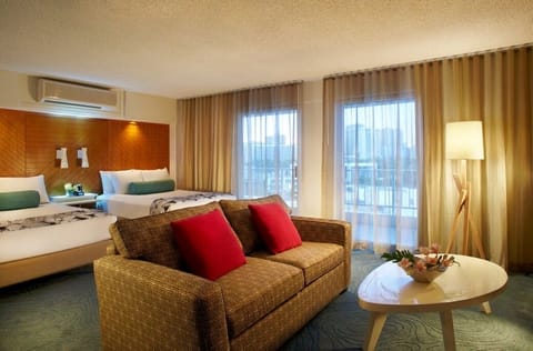Stretch out on the plush sofa beside expansive, sunlit windows.