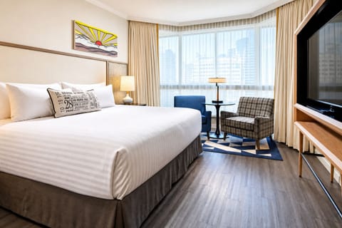 Unwind in crisp linens with sweeping city-window light.