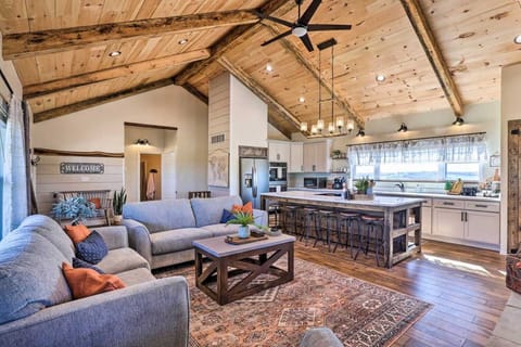 Cozy modern-rustic retreat with vaulted wood ceilings, exposed beams, and abundant natural light. Open-concept living, stylish kitchen with island seating, and scenic views that's perfect for relaxing getaways or entertaining.
