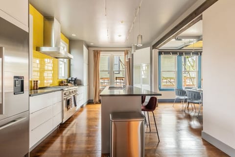 Sleek, fully equipped kitchen with stainless steel appliances, bold backsplash, and ample space for cooking and entertaining.