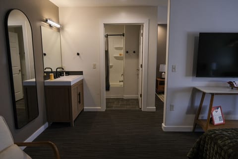 Updated vanity and bathroom area with modern finishes, fresh towels, and plenty of space to get ready.