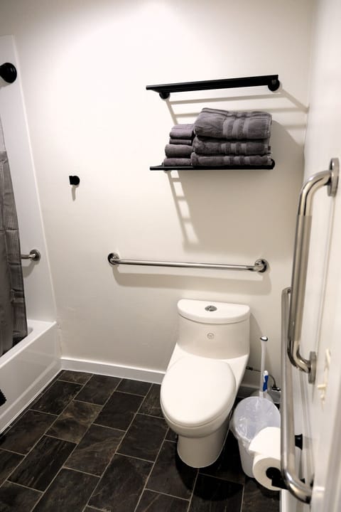 Spacious bathroom with storage shelving, fresh linens, and updated finishes inside this Jackrabbit Moab queen suite.