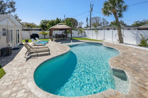 Pool features a sitting ledge in deep end along with a large shallow shelf on opposite end