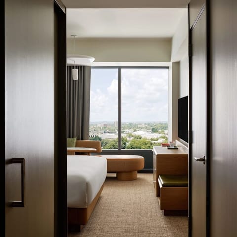 Walk into a bright bedroom framed by panoramic windows.