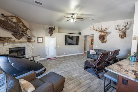 Relax & entertain together — 80” TV, massage chair, and plenty of comfortable seating.