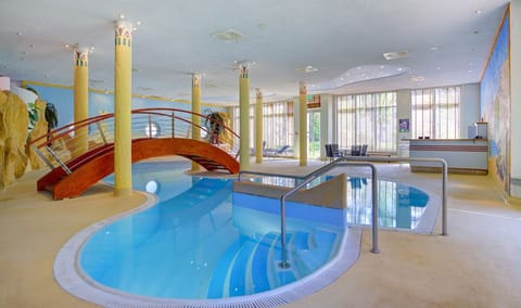 Slip into the warm indoor pool beneath soft skylit ceilings.