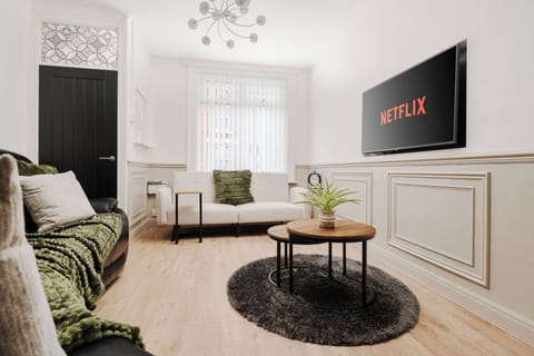 A stylish living area with a Smart TV and Netflix comfortable sofa and separate sofa bed, and ultra-fast 600/900Mbps WiFi. Bright, modern, and perfect for relaxing, streaming, or working comfortably.