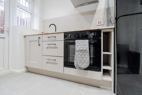 A fully fitted kitchen equipped with everything you need for a comfortable stay, including modern appliances and all the essentials for cooking, dining, and longer visits.