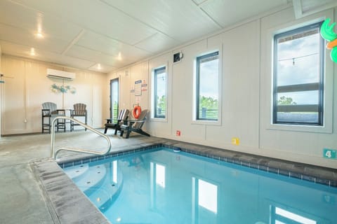 Take a refreshing dip in your own private indoor pool, complete with poolside seating where you can relax and unwind while enjoying views of the surrounding greenery through large windows.